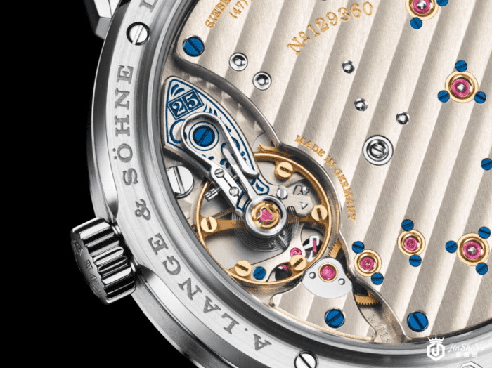 一如25th Anniversary系列的其他表款，手工雕刻蓝色摆轮夹板上缀以周年纪念数字"25"。此数字的排列和方式更与所有照片中朗格大日期显示的数字"25"互相呼应，亦象征着所有周年纪念表款的限量数目